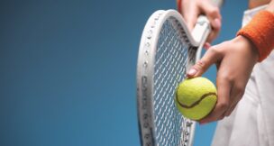 Tennis player holding racket and ball preparing serve